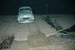 Crossing the river at night on a boat ferry with a bamboo platform on top to hold the car